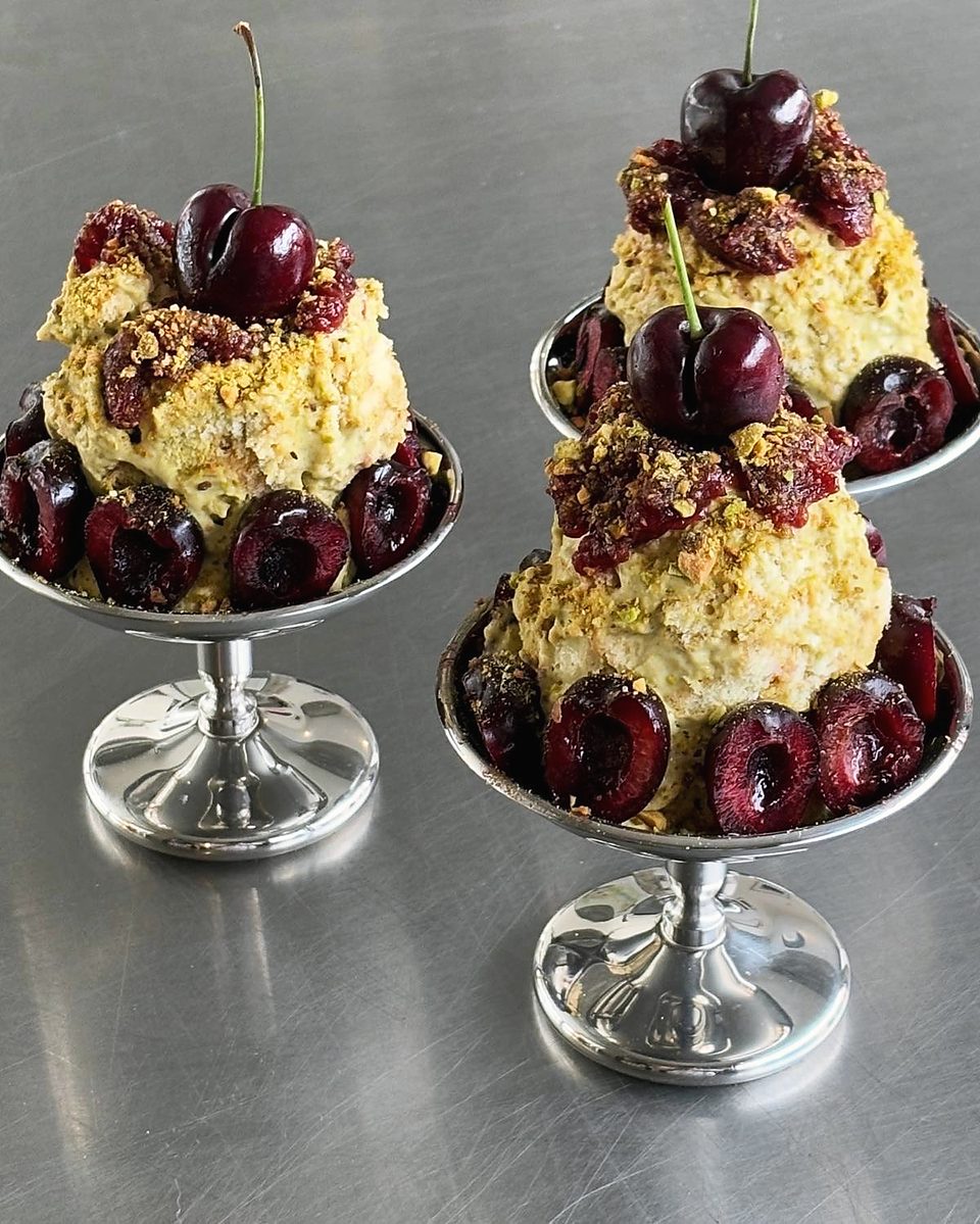 Pistachio and cherry pastries on silver stands