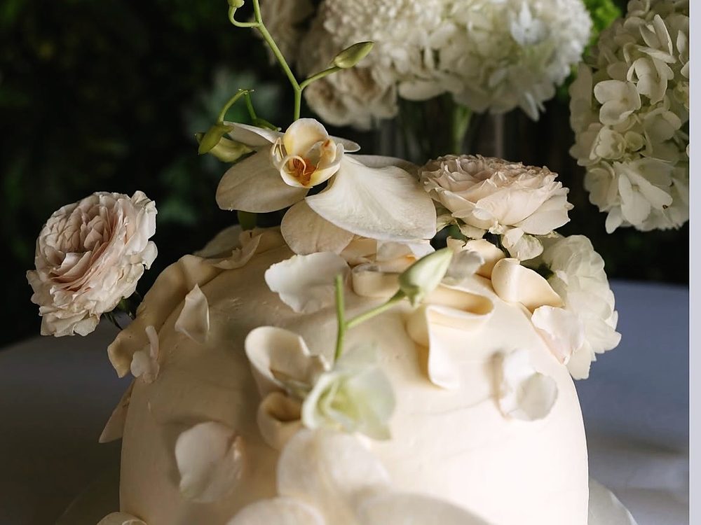 White dome cake with orchids and buttercream florals