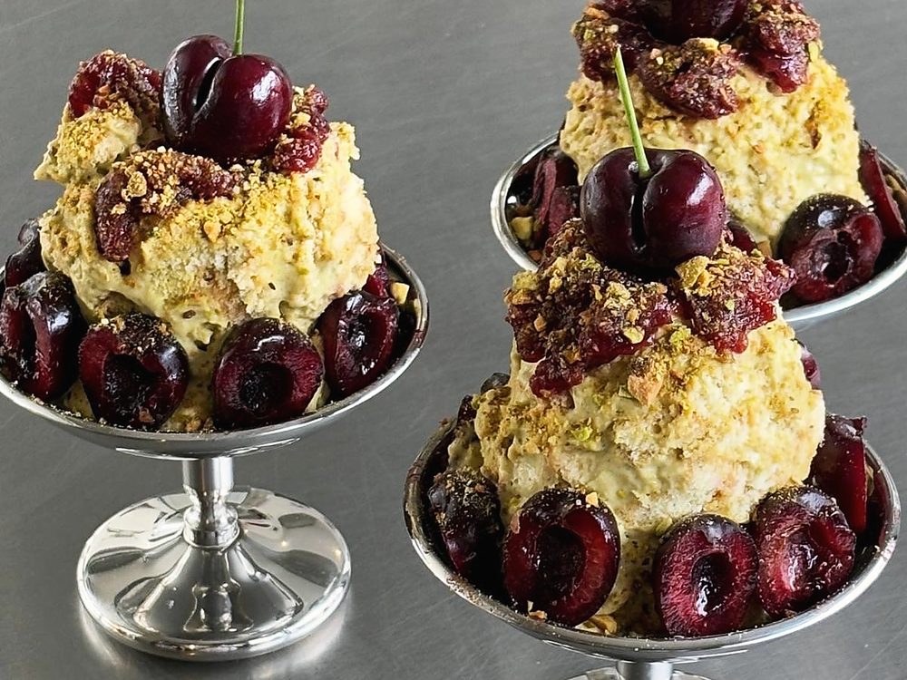 Pistachio and cherry pastries on silver stands
